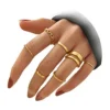 Woman wearing gold knuckle rings set