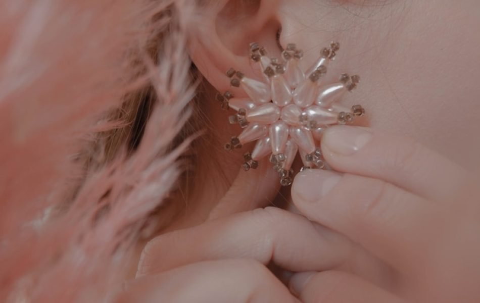 women's white earrings close-up photography