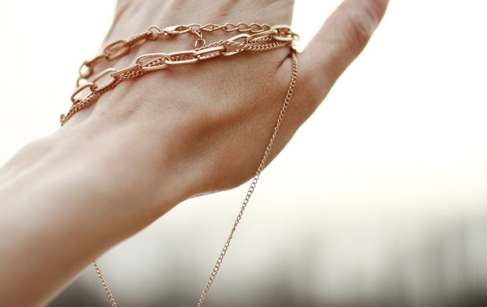 person wearing silver chain bracelet